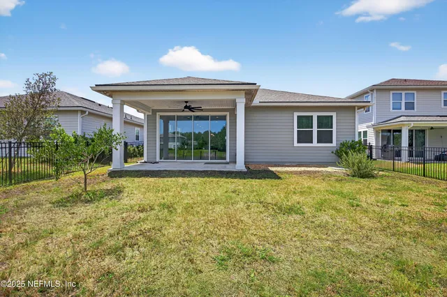 a view of a lake with a big yard and potted plants