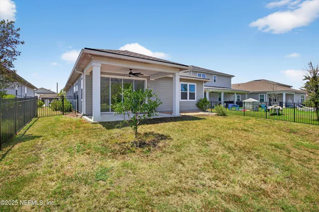 an aerial view of residential houses with yard