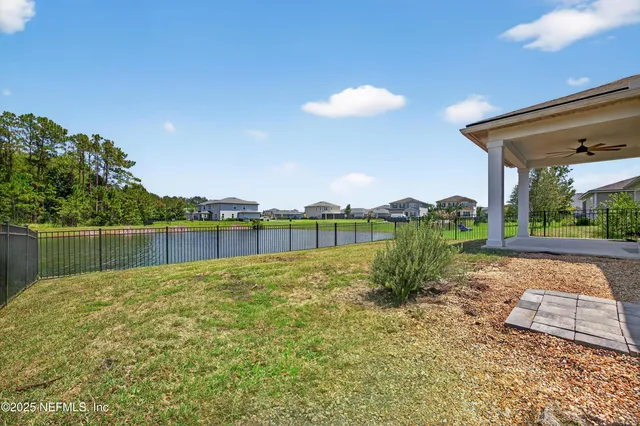 an aerial view of a house with a garden and lake view