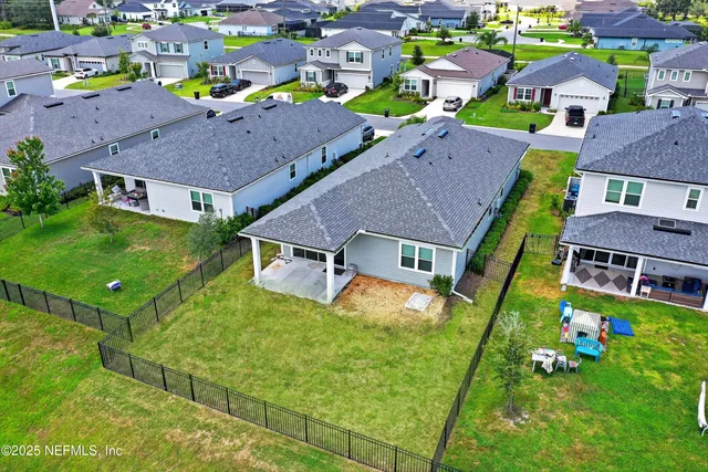 an aerial view of a house with a lake view