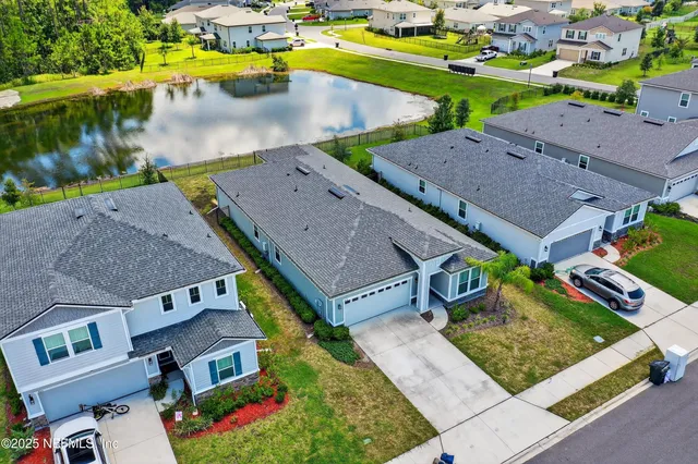 an aerial view of multiple houses with a yard
