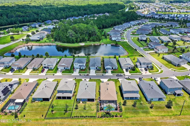 an aerial view of residential houses with yard