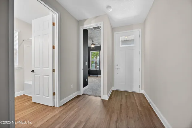 a view of a hallway with wooden floor