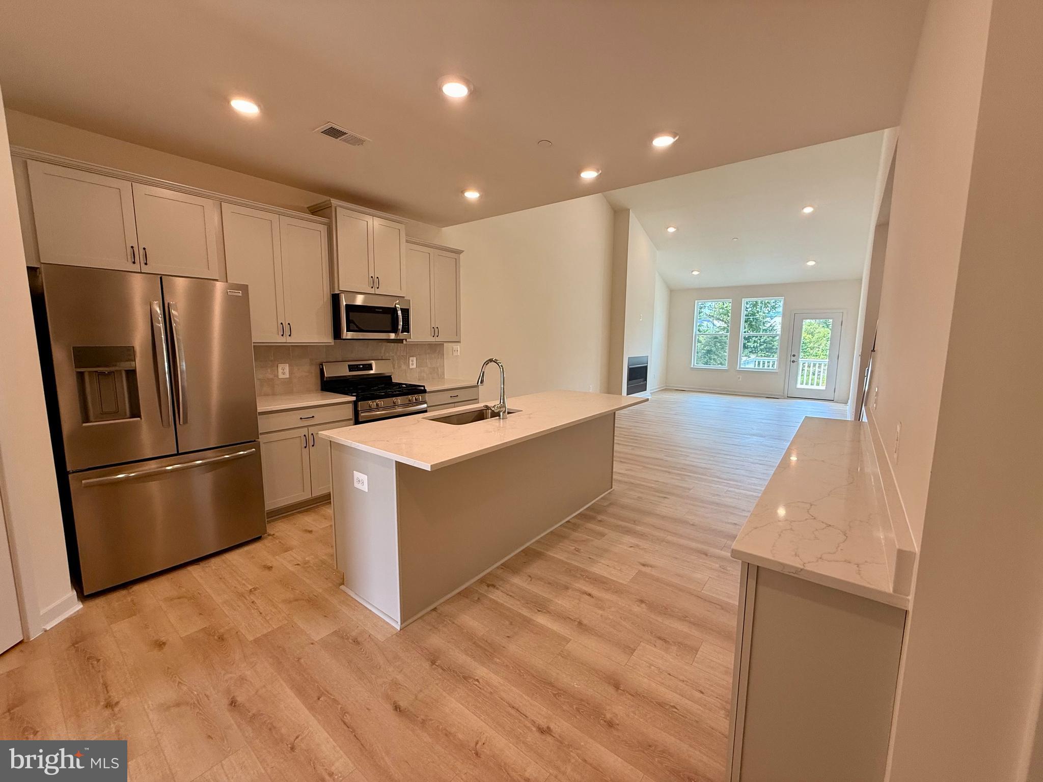 3636 Dexter Court, Unit HARPER142 Aberdeen, MD 21001 - Photo 35 of 40 a large kitchen with stainless steel appliances a refrigerator and a stove top oven