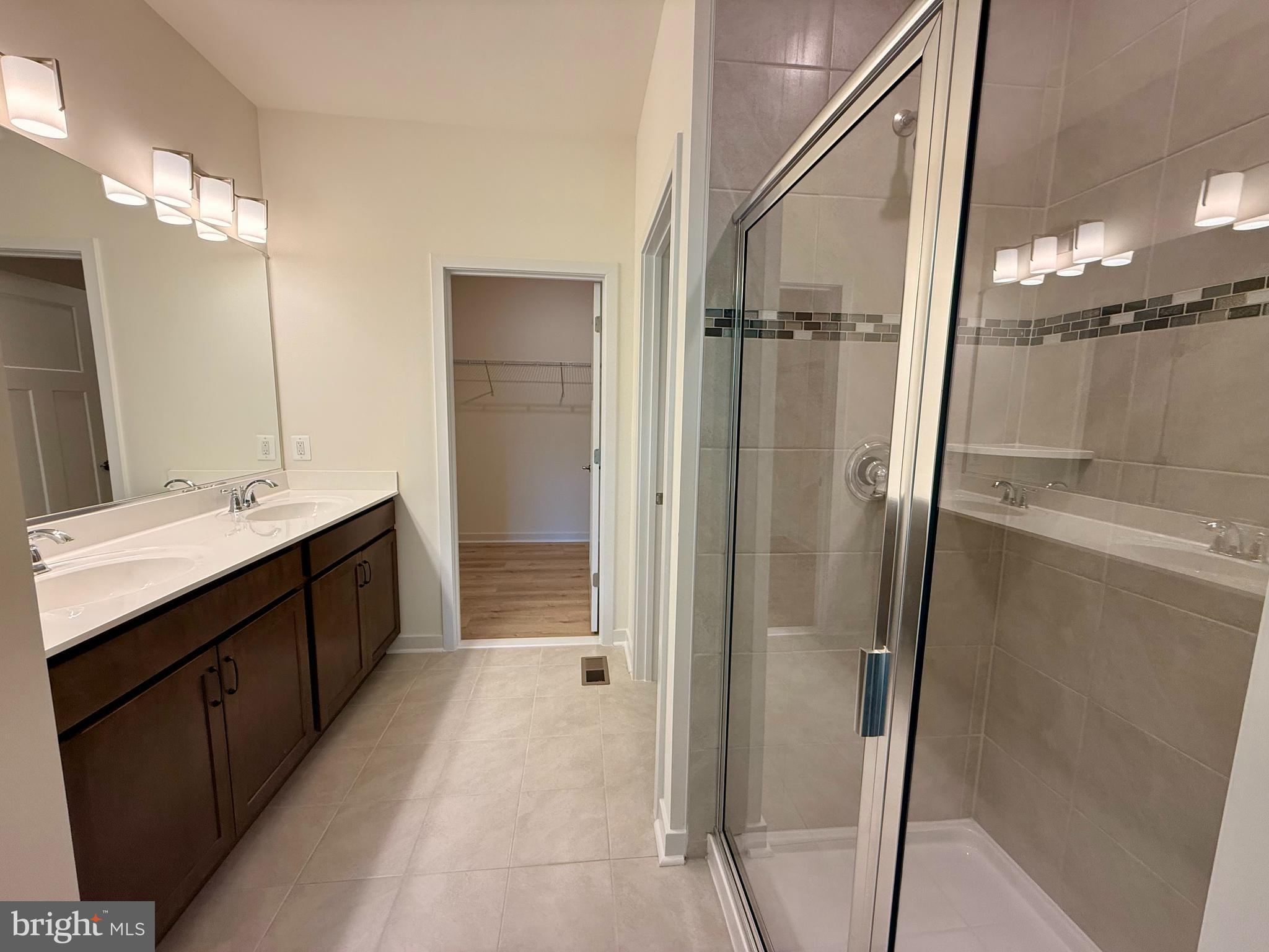 3636 Dexter Court, Unit HARPER142 Aberdeen, MD 21001 - Photo 37 of 40 a bathroom with a double vanity sink a mirror and a shower