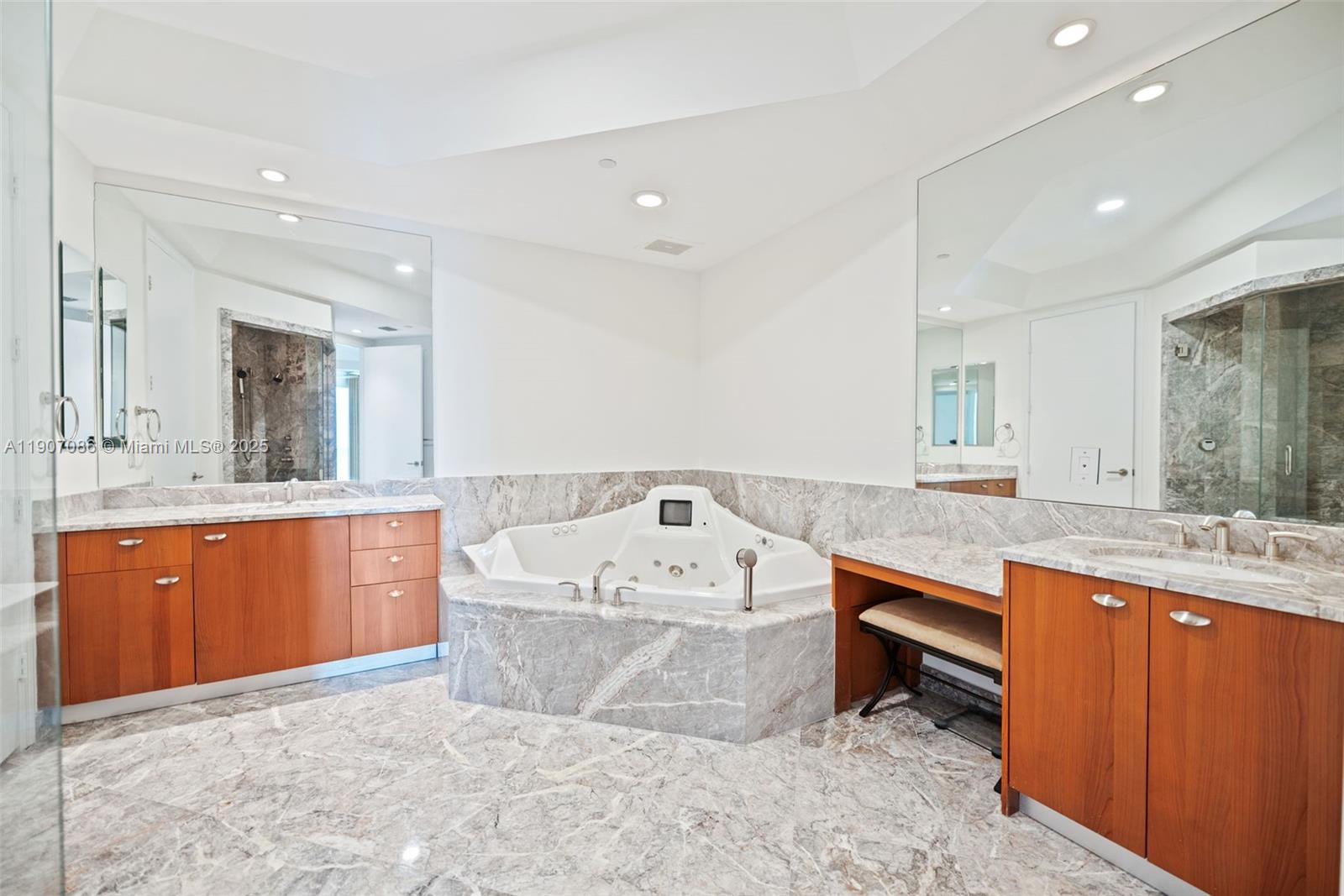 16051 Collins Avenue, Unit 1202 Sunny Isles Beach, FL 33160 - Photo 13 of 32 a large white bathroom with a sink a large mirror and a bathtub