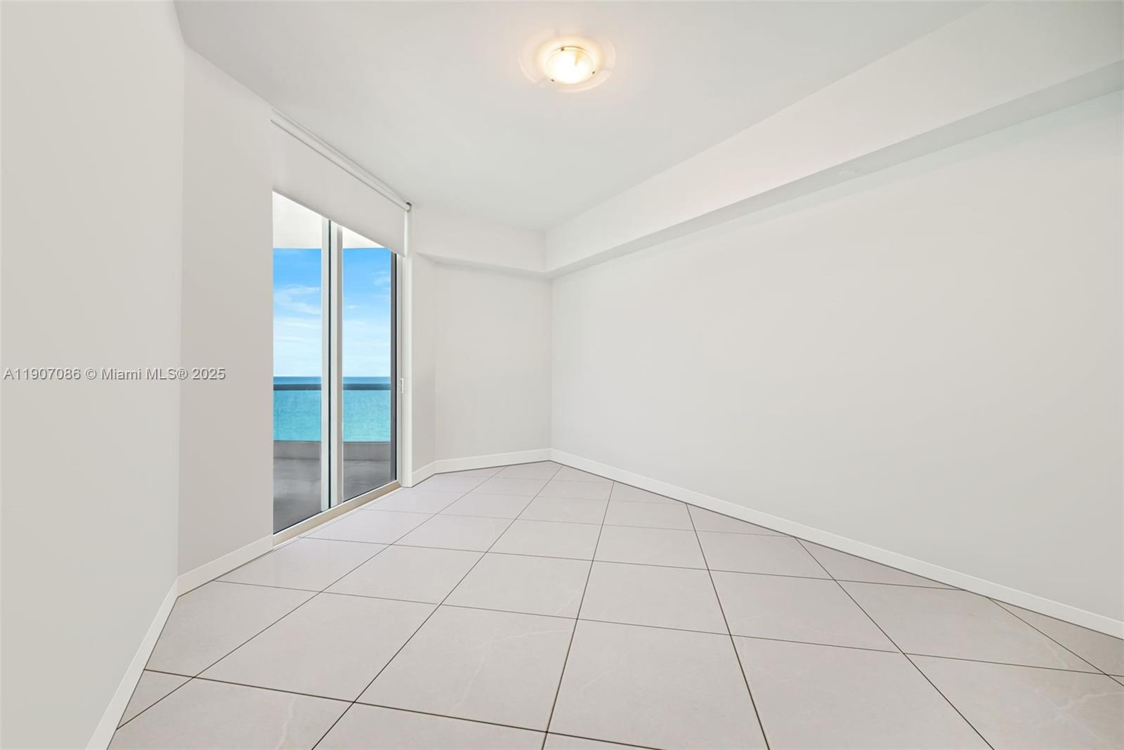 16051 Collins Avenue, Unit 1202 Sunny Isles Beach, FL 33160 - Photo 14 of 32 a view of an empty room with a window