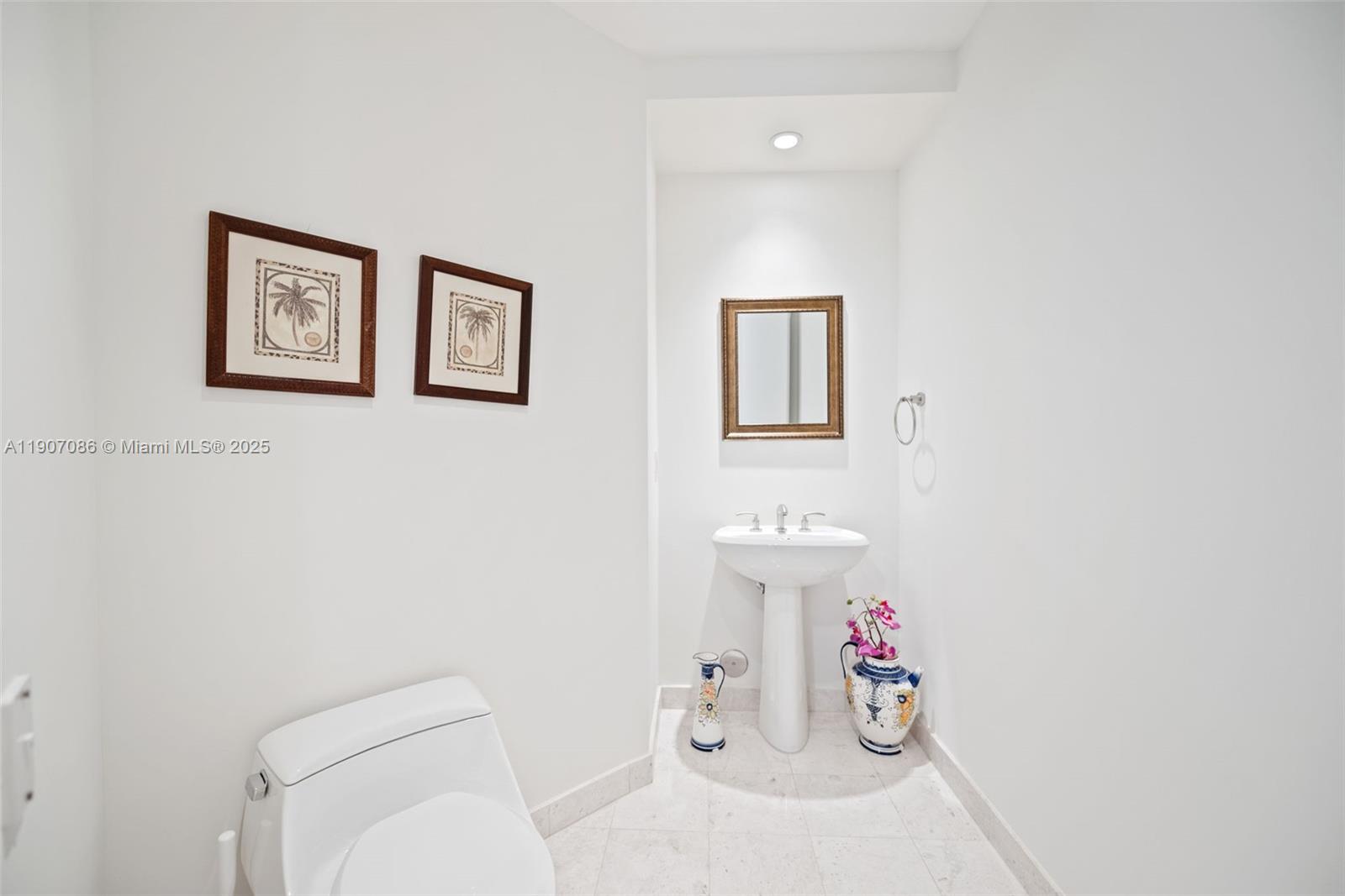 16051 Collins Avenue, Unit 1202 Sunny Isles Beach, FL 33160 - Photo 17 of 32 a bathroom with a toilet sink and a shower