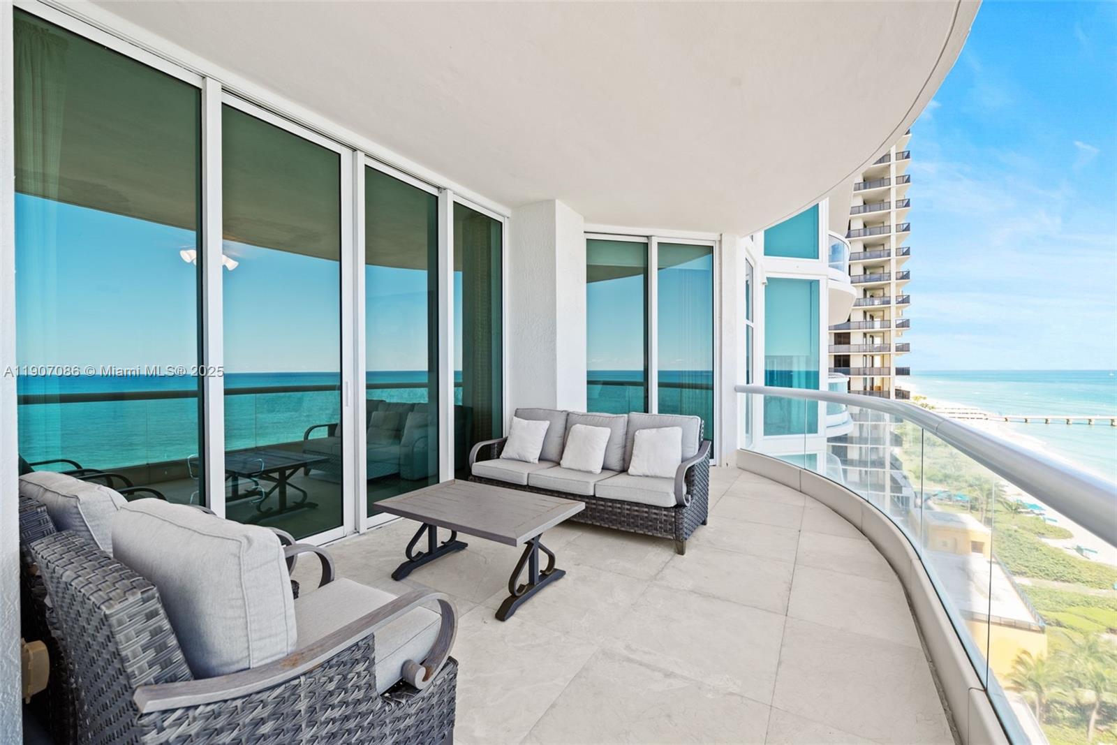 16051 Collins Avenue, Unit 1202 Sunny Isles Beach, FL 33160 - Photo 20 of 32 a living room with furniture and large windows