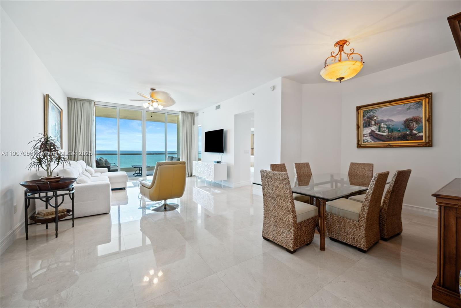 16051 Collins Avenue, Unit 1202 Sunny Isles Beach, FL 33160 - Photo 3 of 32 a living room with furniture a table and chair