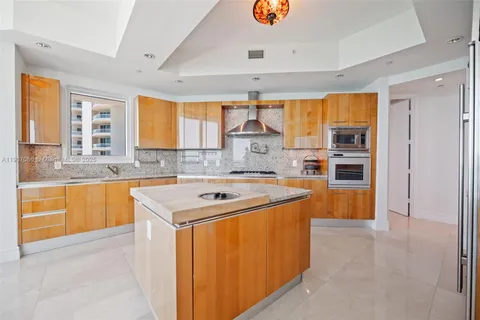 a kitchen with stainless steel appliances granite countertop a sink and cabinets