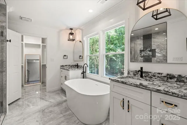 a bathroom with a tub sink and mirror