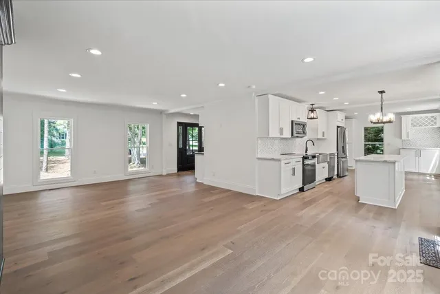 a view of kitchen with furniture and wooden floor