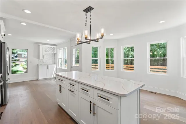 a kitchen with counter top space and windows