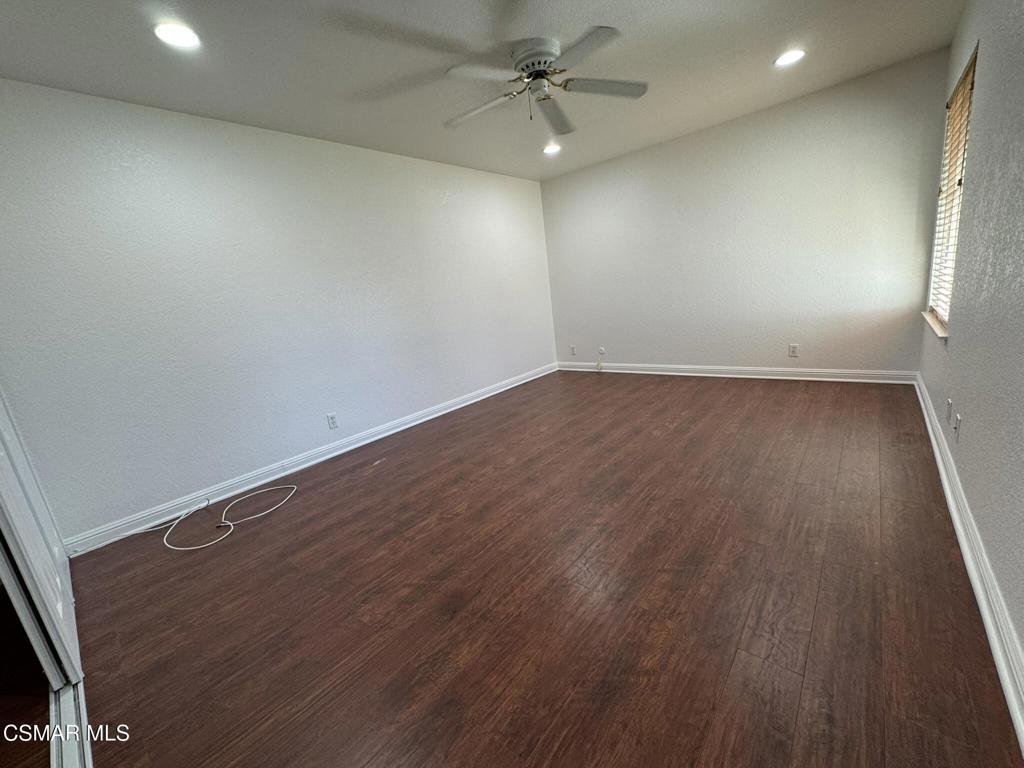 2263 Workman Avenue Simi Valley, CA 93063 - Photo 12 of 17 an empty room with wooden floor fan and windows