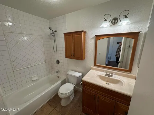a bathroom with a sink double vanity granite tub and shower