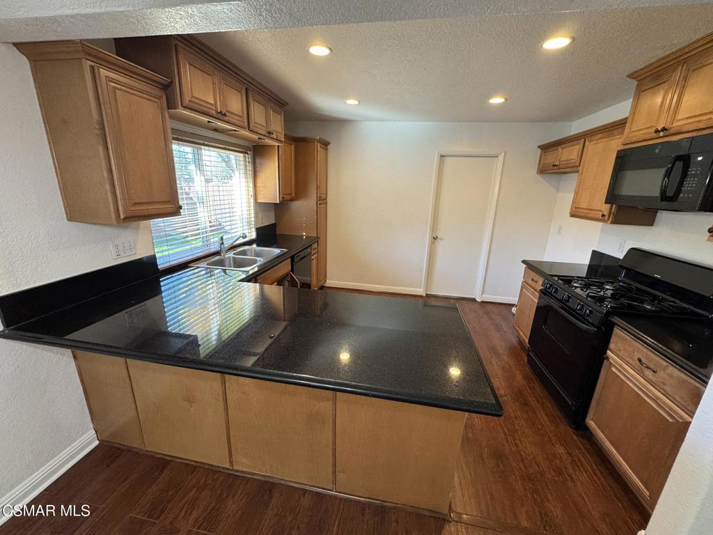 2263 Workman Avenue Simi Valley, CA 93063 - Photo 5 of 17 a kitchen with stainless steel appliances granite countertop a sink stove and refrigerator