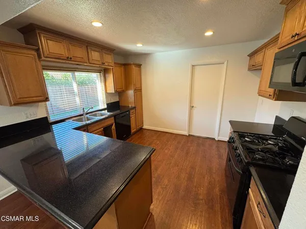 a kitchen with stainless steel appliances granite countertop a stove and a refrigerator