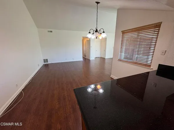 a view of a dining room with furniture and chandelier
