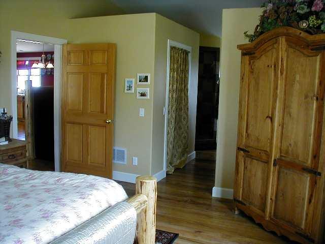 1101 227th Road Rifle, CO 81650 - Photo 5 of 7 a bedroom with a bed and wooden floor