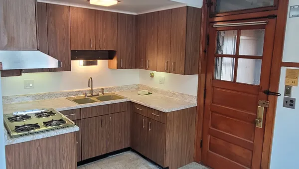 a kitchen with a sink stove and cabinets