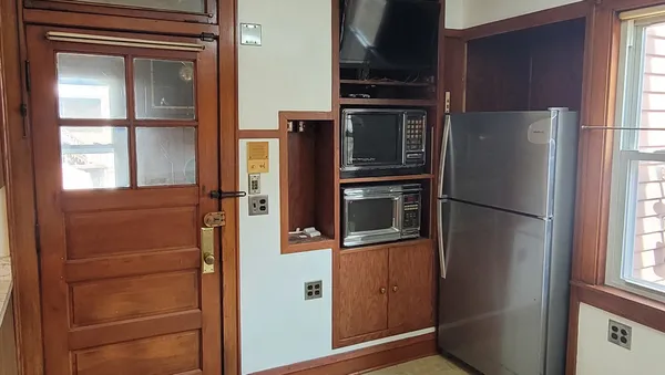 a metallic refrigerator freezer sitting in a kitchen