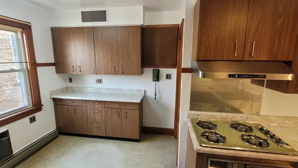 a kitchen with a stove and a refrigerator