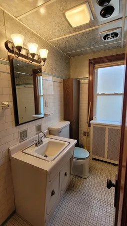 a bathroom with a sink a toilet and mirror