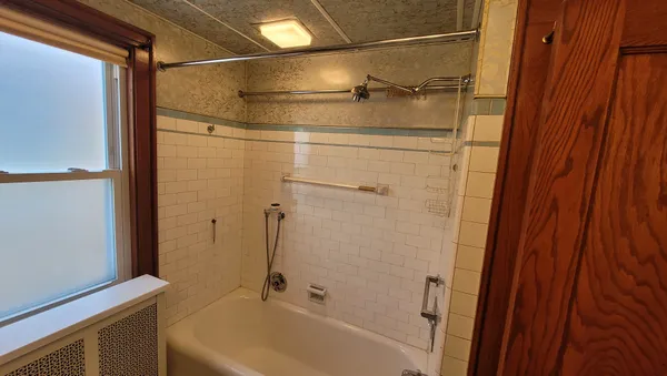 a bathroom with a shower and a bath tub
