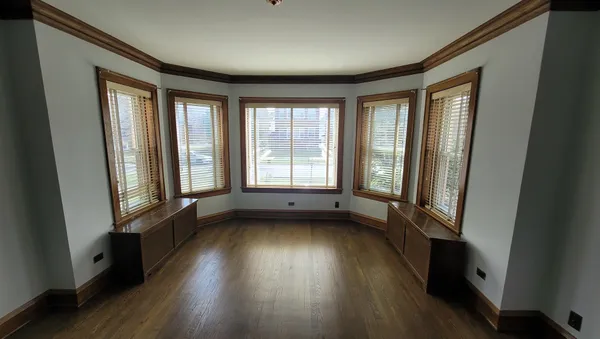 a view of a room with wooden floor and windows