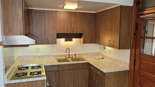 a kitchen with a sink a stove and a refrigerator