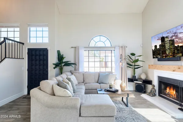 a living room with furniture a potted plant and a fireplace