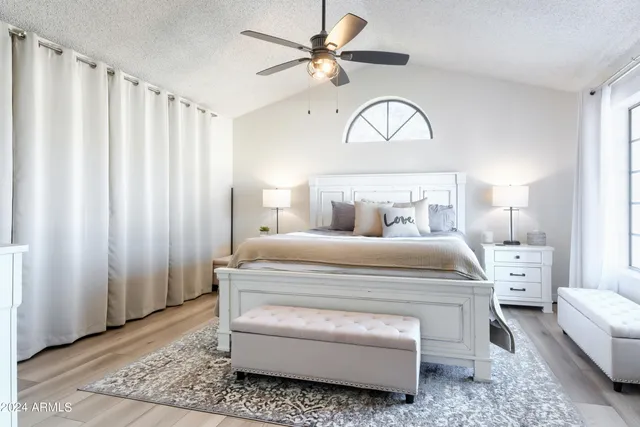 a bedroom with a bed and a chandelier