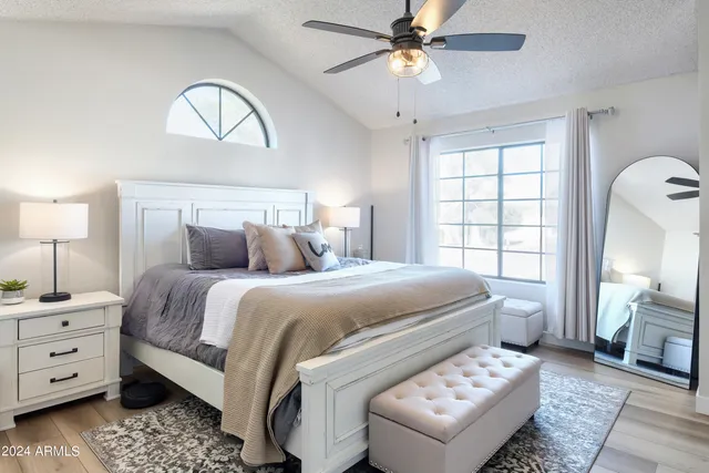 a bedroom with a bed and a chandelier