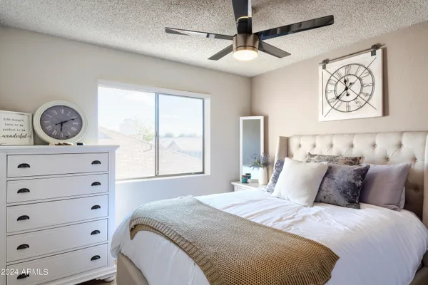 a bedroom with a bed and a dresser