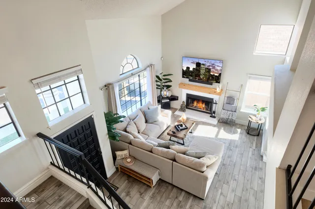 a living room with furniture a fireplace and a flat screen tv
