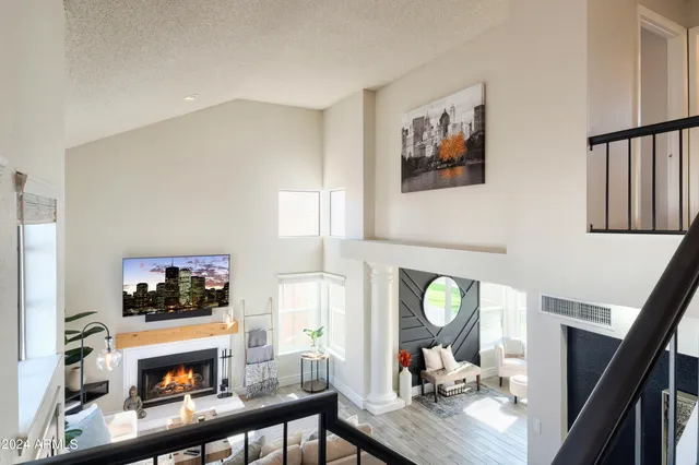 a living room with furniture a fireplace and a flat screen tv