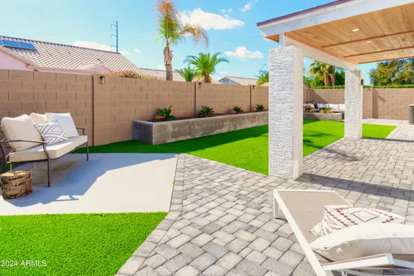 a view of a backyard with sitting area