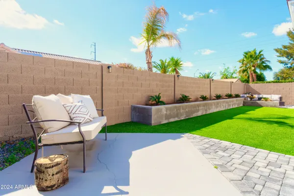 a patio with table and chairs