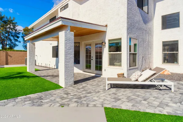 a view of a house with backyard porch and sitting area