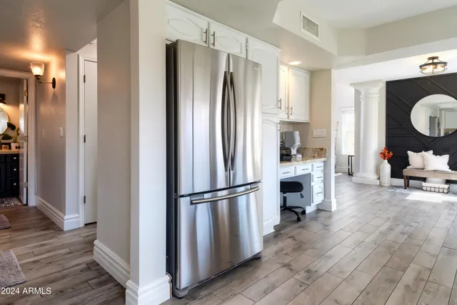 a kitchen with kitchen island a counter top space wooden floor and appliances