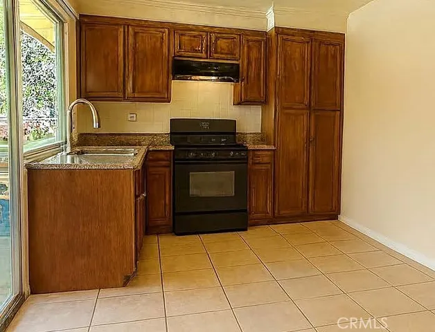 a kitchen with stainless steel appliances granite countertop a stove and a refrigerator