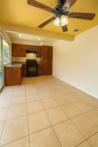 a view of a kitchen with a sink cabinets and appliances