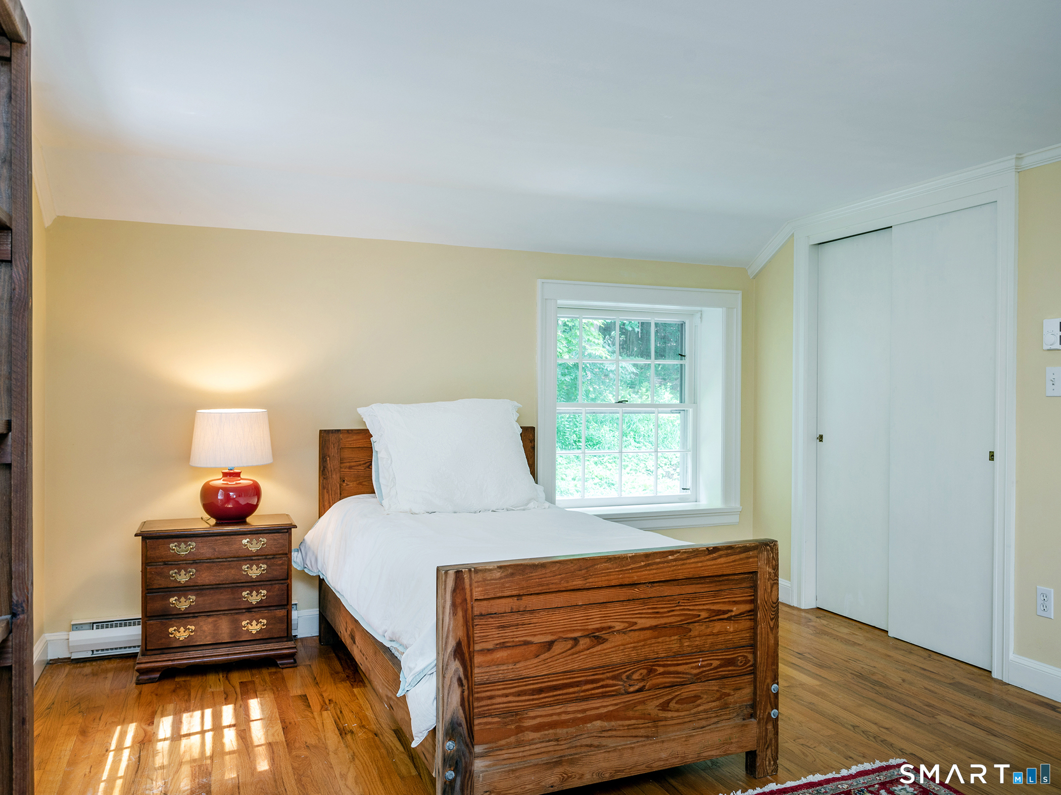 61 Curtiss Road Warren, CT 06777 - Photo 10 of 13 a bedroom with a bed and a window