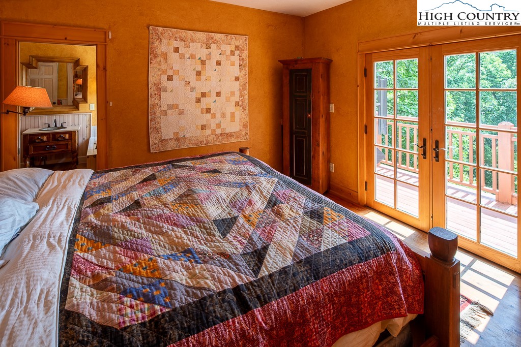 138 Mulberry Lane Boone, NC 28607 - Photo 16 of 33 a bedroom with a bed and wooden floor