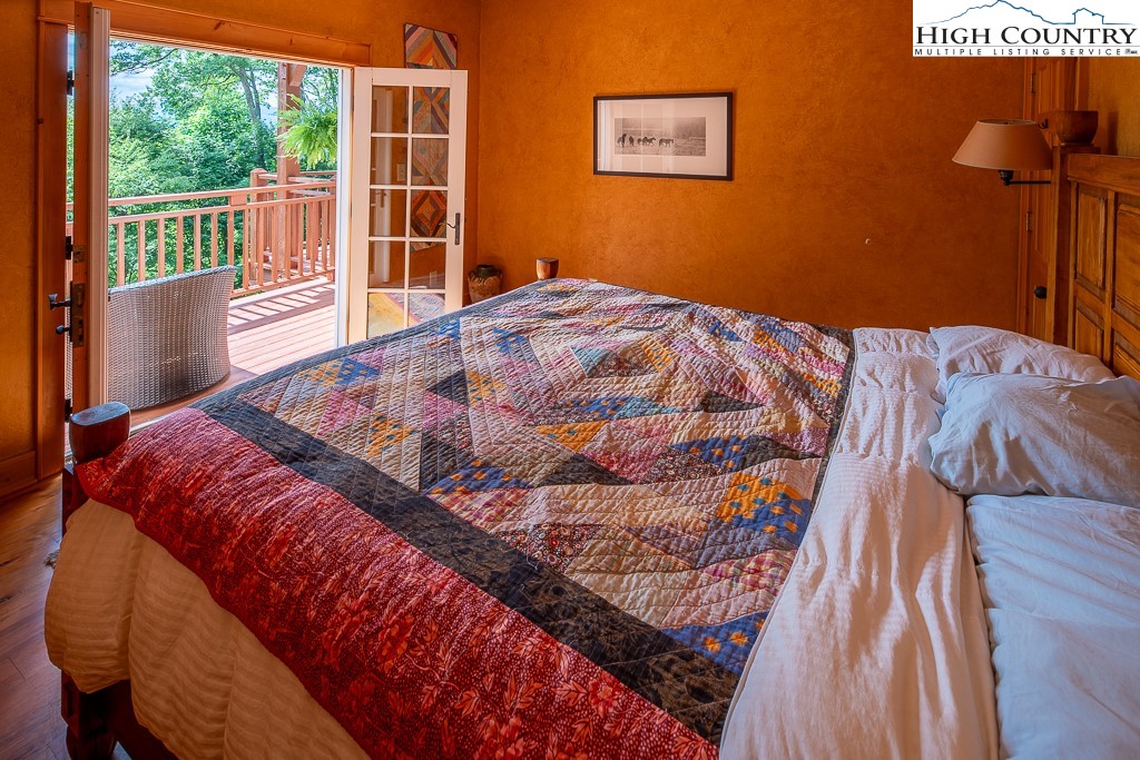 138 Mulberry Lane Boone, NC 28607 - Photo 17 of 33 a bedroom with a bed and wooden floor