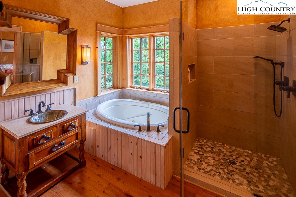 138 Mulberry Lane Boone, NC 28607 - Photo 19 of 33 a bathroom with a tub sink shower and mirror