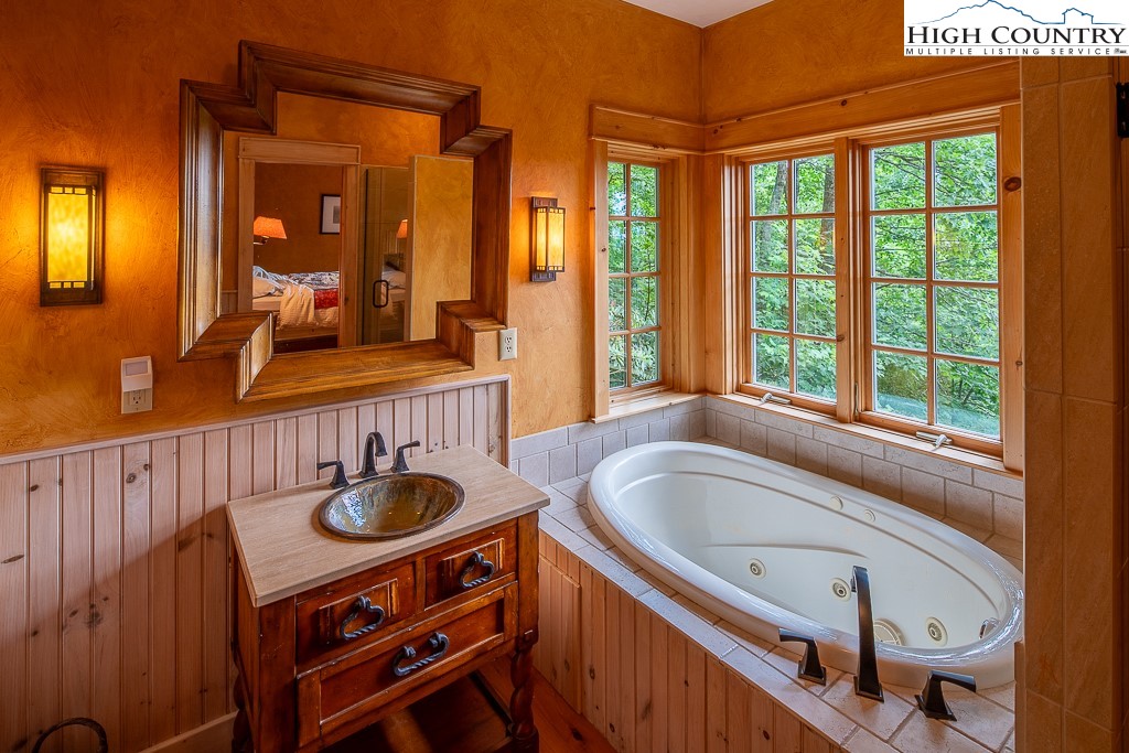 138 Mulberry Lane Boone, NC 28607 - Photo 20 of 33 a bathroom with a granite countertop sink and a large mirror