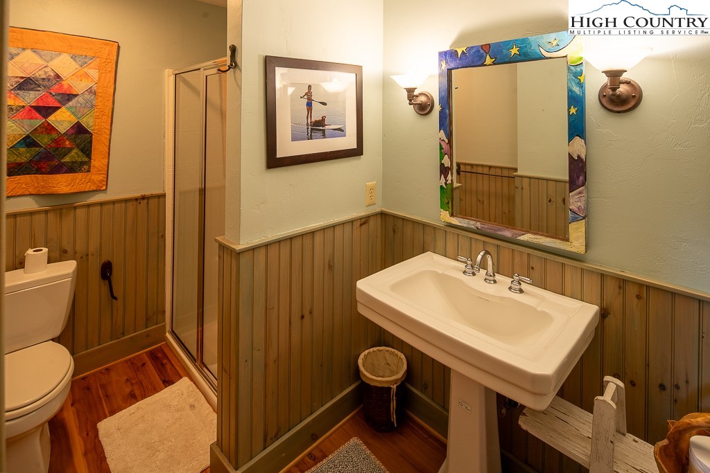 138 Mulberry Lane Boone, NC 28607 - Photo 22 of 33 a bathroom with a toilet a sink and mirror