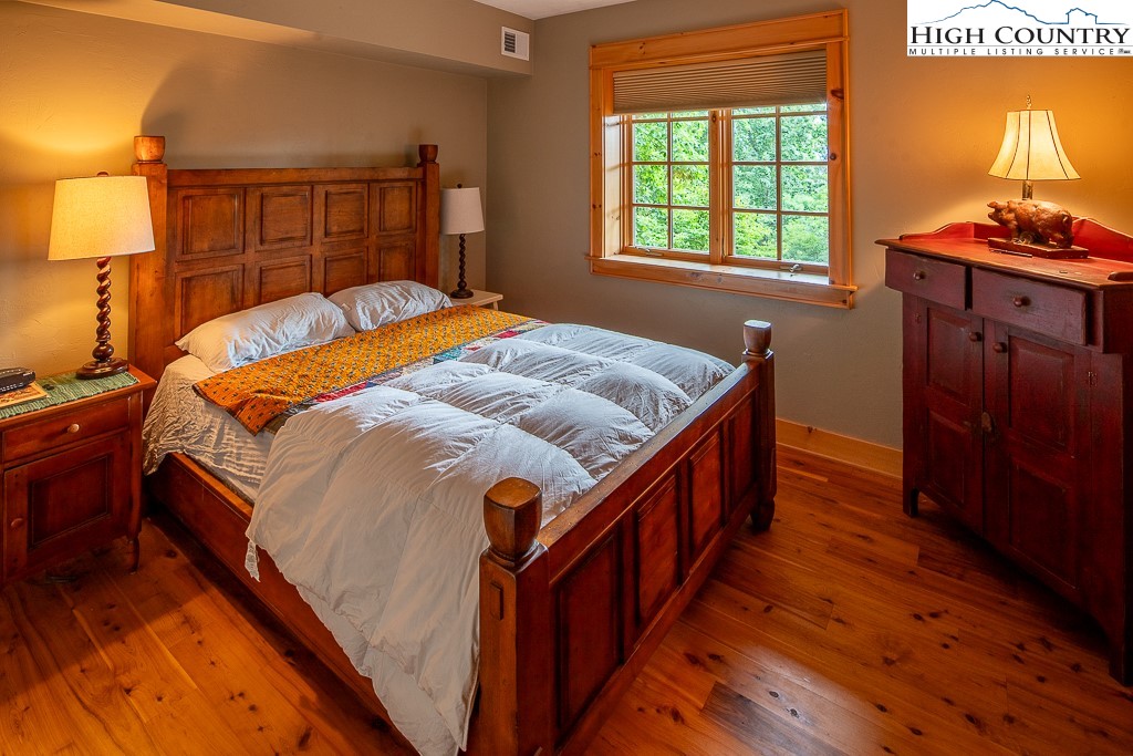 138 Mulberry Lane Boone, NC 28607 - Photo 23 of 33 a bed sitting in a bedroom next to a window